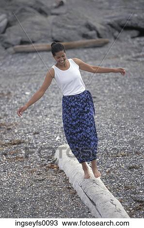 Smiling African American Woman Balancing On A Log On A Rocky Beach View Large Photo Image Stock Image - Smiling African American Woman Balancing On A Log On A Rocky Beach. Fotosearch