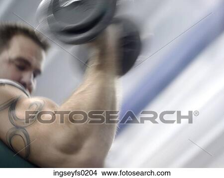 Tattooed Caucasian Man Lifting Weights In Gym View Large Photo Image Picture - Tattooed Caucasian Man Lifting Weights In Gym. Fotosearch