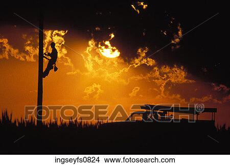 Telephone Pole Worker And Sunset View Large Photo Image Picture - Telephone Pole Worker And Sunset. Fotosearch