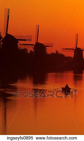 Stock Photography - Windmills on the River. Fotosearch