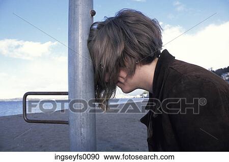 Woman Resting Her Head Against A Pole On The Beach View Large Photo Image Stock Image - Woman Resting Her Head Against A Pole On The Beach. Fotosearch
