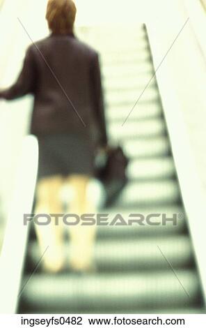 Woman Riding Up Escalator View Large Photo Image Stock Image - Woman Riding Up Escalator. Fotosearch
