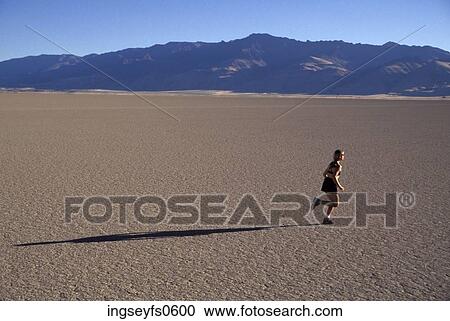 Woman Running on Dry Baked Mud View Large Photo Image Stock Image - Woman Running on Dry Baked Mud. Fotosearch