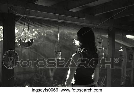 Woman Standing On The Porch Of Her Rural Home And Looking Toward The Sun View Large Photo Image Stock Photograph - Woman Standing On The Porch Of Her Rural Home And Looking Toward The Sun. Fotosearch