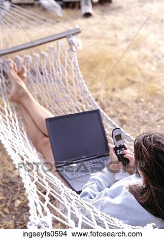 Woman Using Cell Phone and Laptop View Large Photo Image Picture - Woman Using Cell Phone and Laptop. Fotosearch