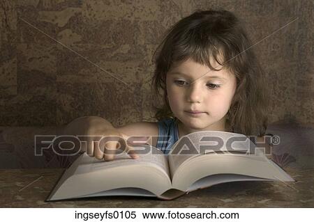Stock Photography - Young Girl Reading From A Big Book. Fotosearch