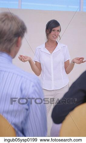 Stock Photo - Businesswoman giving a presentation during a meeting. Fotosearch