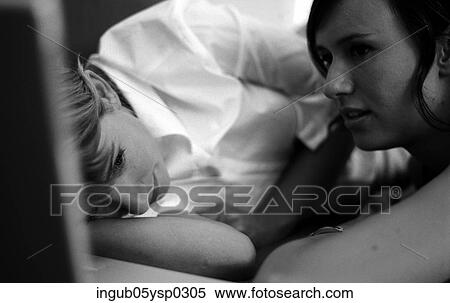 Stock Photography - Close-up of a two young women lying together. Fotosearch