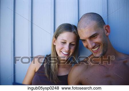 Close-up of a young couple smiling View Large Photo Image Stock Photo - Close-up of a young couple smiling. Fotosearch