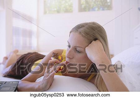Close-up of a young woman eating a chocolate bar View Large Photo Image Stock Image - Close-up of a young woman eating a chocolate bar. Fotosearch