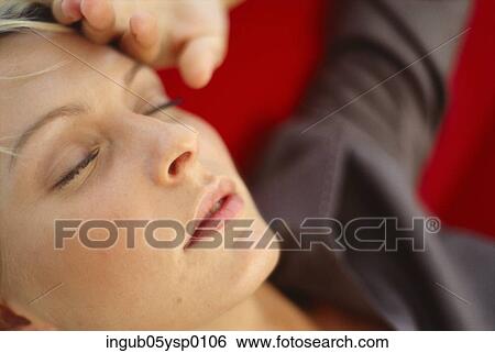 Close-up of a young woman lying down with her eyes closed View Large Photo Image Stock Photograph - Close-up of a young woman lying down with her eyes closed. Fotosearch