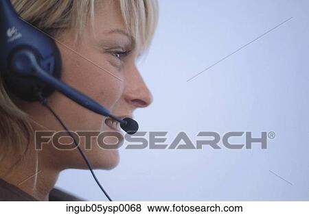 Stock Photo - Close-up of a young woman wearing a headset. Fotosearch