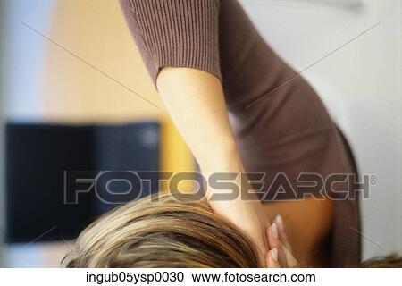 Close-up of a young woman with her hands on her neck View Large Photo Image Stock Image - Close-up of a young woman with her hands on her neck. Fotosearch