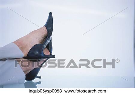 Stock Image - Close-up of high heel shoes on a woman's feet. Fotosearch