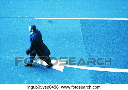 High angle view of a businessman crossing a road View Large Photo Image Stock Photograph - High angle view of a businessman crossing a road. Fotosearch