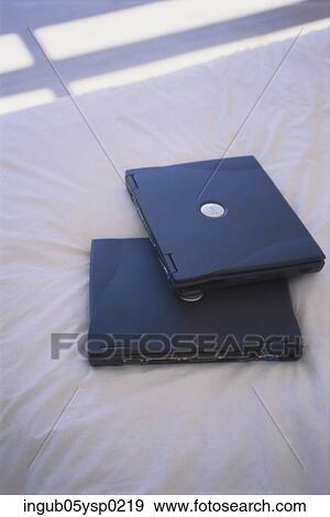 Stock Photo - High angle view of two laptops on a bed. Fotosearch