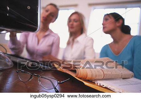 Picture - Low angle view of three young women in an office. Fotosearch