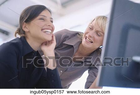 Low angle view of two young woman laughing together View Large Photo Image Stock Photo - Low angle view of two young woman laughing together. Fotosearch