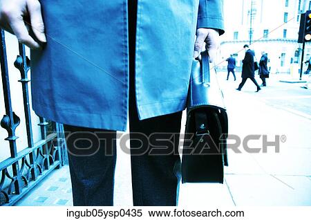 Low-section view of a businessman carrying a briefcase View Large Photo Image Stock Photography - Low-section view of a businessman carrying a briefcase. Fotosearch