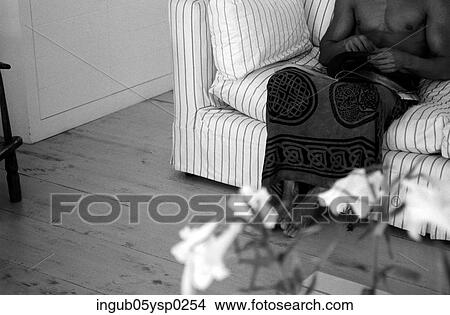 Low-section view of a man sitting on a couch in a sarong View Large Photo Image Picture - Low-section view of a man sitting on a couch in a sarong. Fotosearch