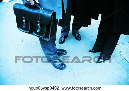 Low-section view of three people standing on the street View Large Photo Image Stock Image - Low-section view of three people standing on the street. Fotosearch