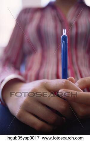 Mid section view of a person holding a pen View Large Photo Image Stock Photo - Mid section view of a person holding a pen. Fotosearch
