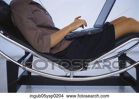 Midsection view of a businesswoman working on a laptop View Large Photo Image Picture - Midsection view of a businesswoman working on a laptop. Fotosearch
