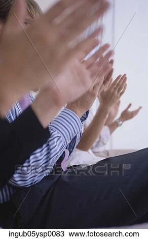 Stock Image - Midsection view of a group of people clapping. Fotosearch