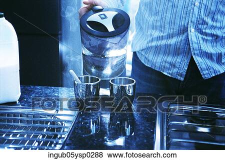 Stock Photo - Midsection view of a man making coffee. Fotosearch