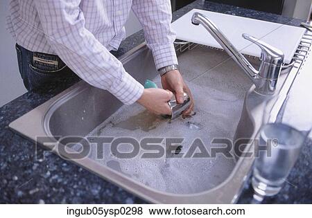 Midsection view of a man washing dishes View Large Photo Image Stock Photo - Midsection view of a man washing dishes. Fotosearch