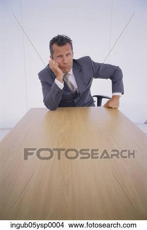 Portrait of a businessman sitting in a conference room View Large Photo Image Picture - Portrait of a businessman sitting in a conference room. Fotosearch