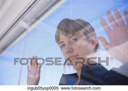 Portrait of a businesswoman looking through a window View Large Photo Image Stock Photography - Portrait of a businesswoman looking through a window. Fotosearch