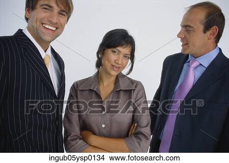 Portrait of a businesswoman standing between two businessmen View Large Photo Image Picture - Portrait of a businesswoman standing between two businessmen. Fotosearch