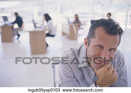 Portrait of a mid adult man holding his chin View Large Photo Image Stock Image - Portrait of a mid adult man holding his chin. Fotosearch