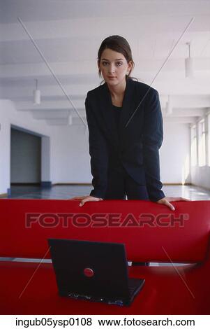Portrait of a young businesswoman standing behind a couch View Large Photo Image Stock Photo - Portrait of a young businesswoman standing behind a couch. Fotosearch