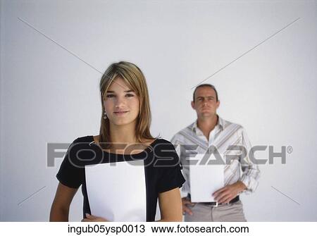 Portrait of a young couple holding blank sheets View Large Photo Image Stock Image - Portrait of a young couple holding blank sheets. Fotosearch