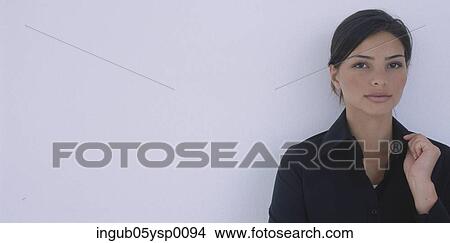 Picture - Portrait of a young woman holding her collar. Fotosearch