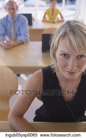 Stock Photography - Portrait of a young woman in an office. Fotosearch
