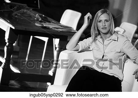 Portrait of a young woman sitting on an armchair View Large Photo Image Stock Image - Portrait of a young woman sitting on an armchair. Fotosearch