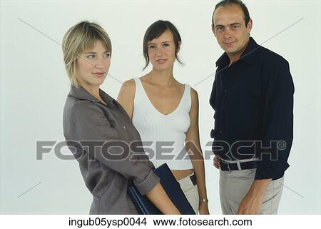 Picture - Portrait of two young women standing with a young man. Fotosearch