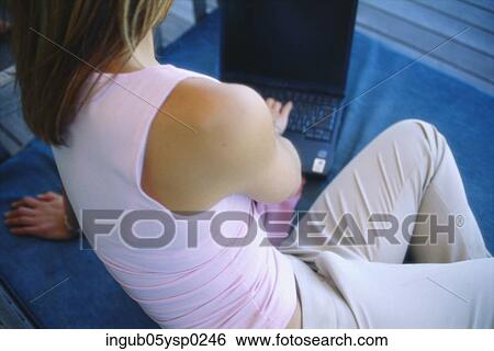 Real view of a young woman working on a laptop View Large Photo Image Stock Photograph - Real view of a young woman working on a laptop. Fotosearch