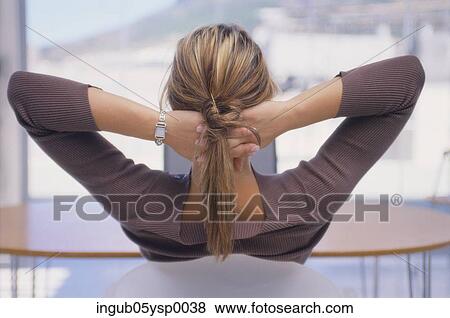 Rear view of a young woman reclining with her hands behind her head View Large Photo Image Stock Photo - Rear view of a young woman reclining with her hands behind her head. Fotosearch