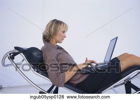 Side profile of a businesswoman working on a laptop View Large Photo Image Stock Photo - Side profile of a businesswoman working on a laptop. Fotosearch