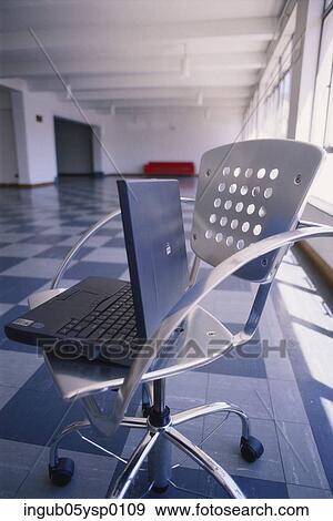 Side profile of a laptop on a chair View Large Photo Image Stock Photo - Side profile of a laptop on a chair. Fotosearch