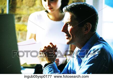 Side profile of a mid adult man looking at a computer screen View Large Photo Image Stock Photo - Side profile of a mid adult man looking at a computer screen. Fotosearch