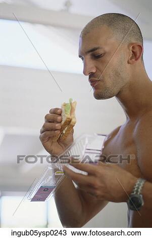Side profile of a young man eating a sandwich View Large Photo Image Stock Image - Side profile of a young man eating a sandwich. Fotosearch
