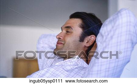 Side profile of a young man reclining with his hands behind his head View Large Photo Image Stock Image - Side profile of a young man reclining with his hands behind his head. Fotosearch
