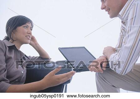 Side profile of a young woman and a young man talking View Large Photo Image Stock Image - Side profile of a young woman and a young man talking. Fotosearch