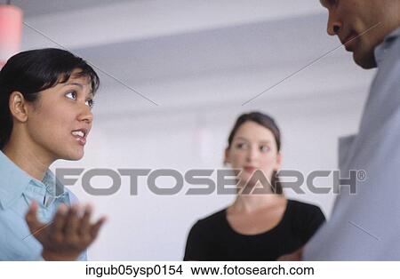 Picture - Side profile of a young woman talking to a young man. Fotosearch