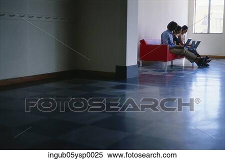 Side profile of two young women and a young man sitting on a couch with laptops View Large Photo Image Stock Photography - Side profile of two young women and a young man sitting on a couch with laptops. Fotosearch